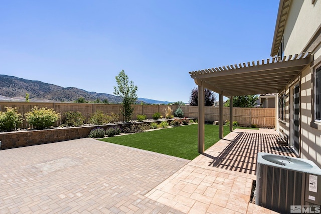 view of patio / terrace featuring a pergola, central AC unit, a mountain view, and a fenced backyard