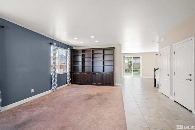 unfurnished room featuring recessed lighting, baseboards, plenty of natural light, and light tile patterned flooring