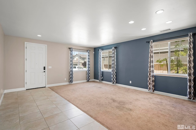 tiled spare room featuring visible vents, recessed lighting, baseboards, and carpet