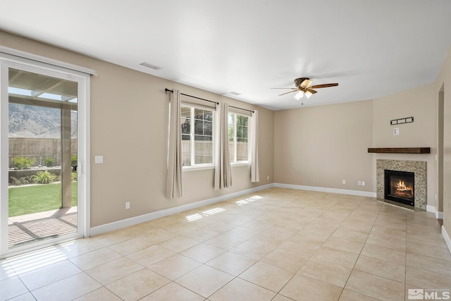 unfurnished living room featuring light tile patterned floors, visible vents, ceiling fan, and baseboards