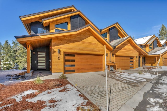 view of front of house featuring decorative driveway and a garage