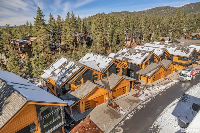 bird's eye view with a wooded view