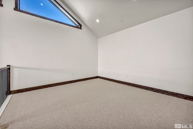 carpeted empty room featuring recessed lighting, baseboards, and high vaulted ceiling