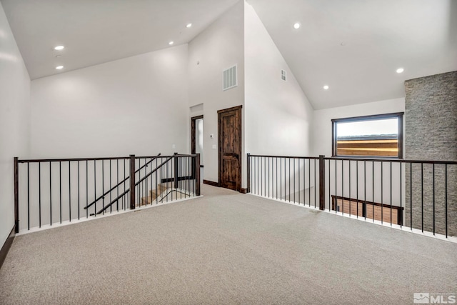 unfurnished room with recessed lighting, visible vents, high vaulted ceiling, and carpet flooring