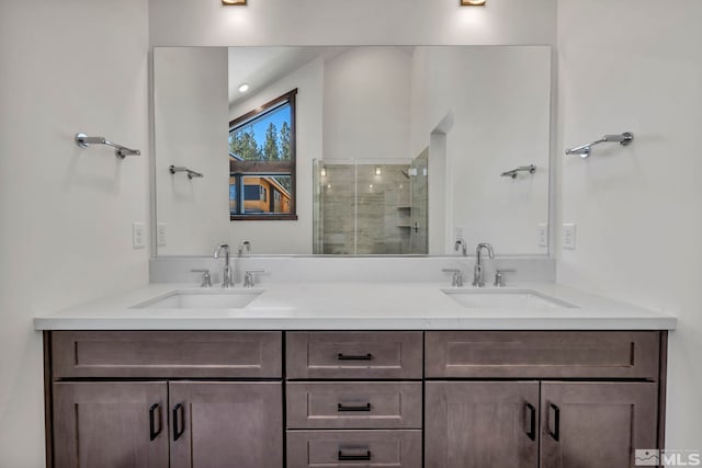 full bath featuring double vanity, a stall shower, and a sink