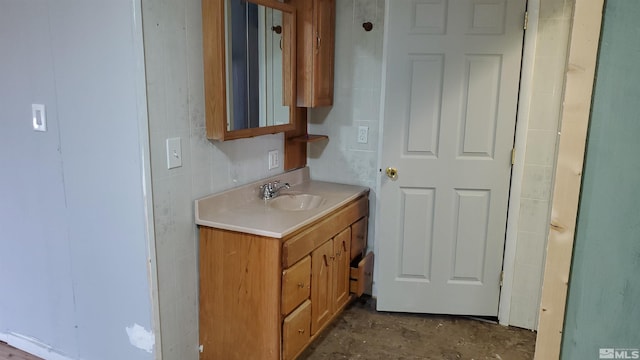 bathroom featuring unfinished concrete floors, tile walls, and vanity