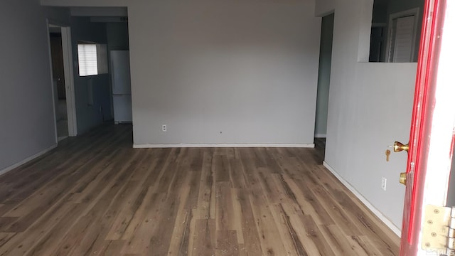spare room with wood finished floors