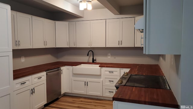 kitchen with range with electric cooktop, butcher block countertops, a sink, stainless steel dishwasher, and white cabinetry