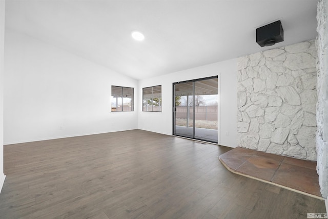 empty room featuring lofted ceiling and wood finished floors