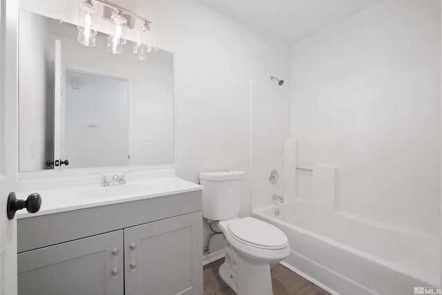 full bath featuring toilet, vanity, shower / bathing tub combination, and wood finished floors