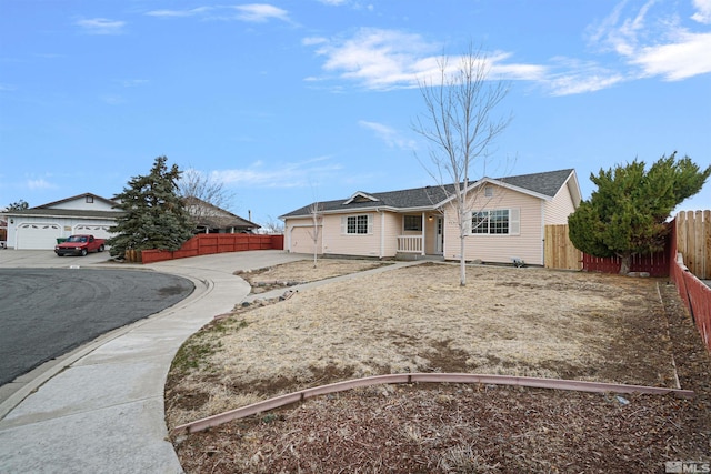 ranch-style house with concrete driveway, a garage, and fence