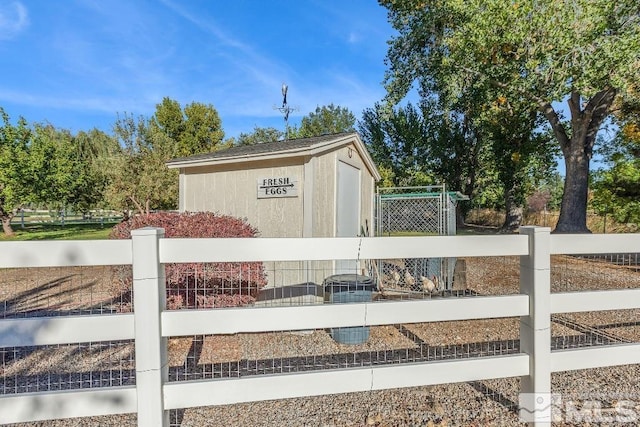 view of outbuilding with an outbuilding and fence