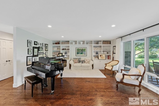 living area featuring recessed lighting, wood finished floors, and built in shelves