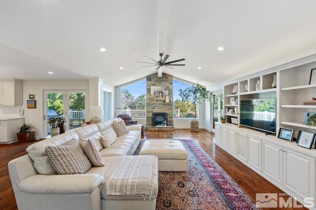 living area with wood finished floors, lofted ceiling with beams, a fireplace, recessed lighting, and ceiling fan