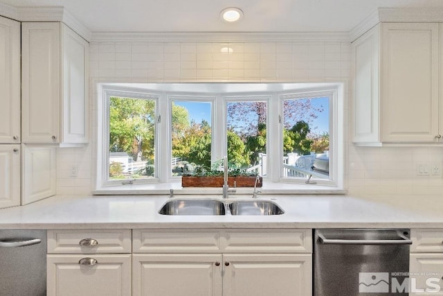 kitchen featuring a sink, stainless steel dishwasher, white cabinets, and light countertops