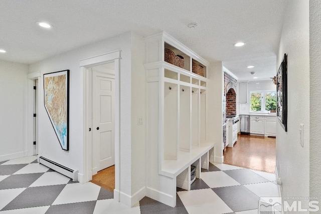 mudroom featuring recessed lighting, light floors, and a baseboard radiator