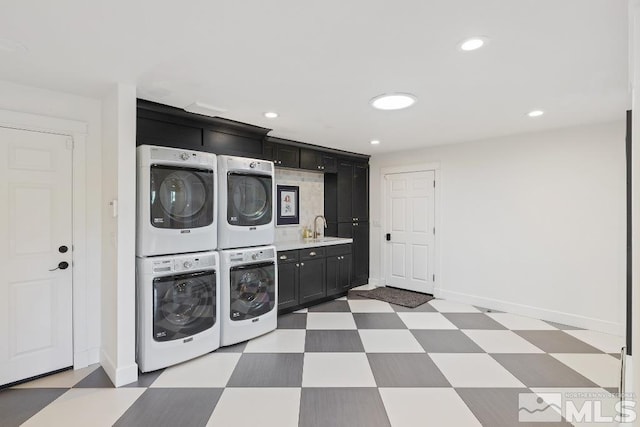 laundry area with cabinet space, recessed lighting, light floors, and stacked washer / drying machine