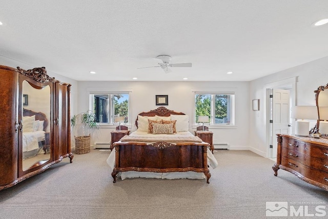 bedroom featuring recessed lighting, light colored carpet, and a baseboard heating unit