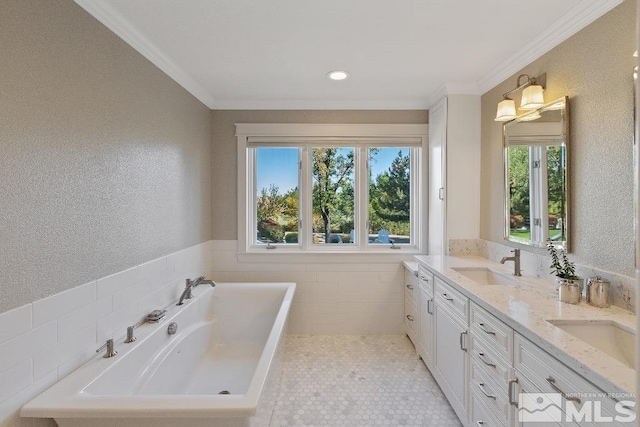 bathroom with a sink, a bathing tub, tile walls, and ornamental molding