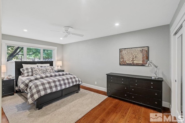 bedroom with a ceiling fan, recessed lighting, wood finished floors, and baseboards