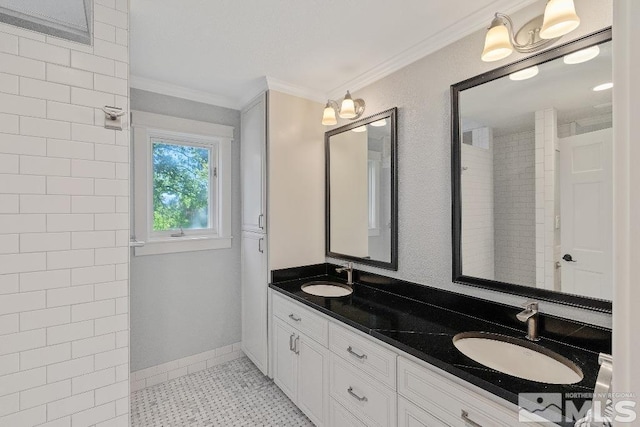 full bath featuring double vanity, ornamental molding, and a sink