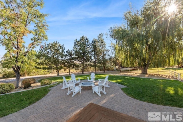 view of patio featuring fence and an outdoor fire pit