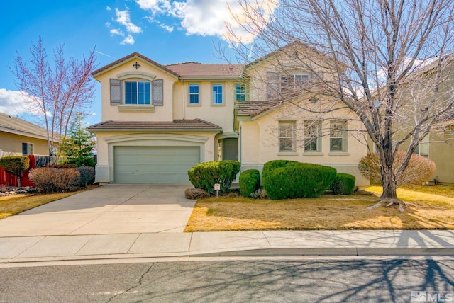 view of front of house featuring stucco siding, driveway, a tile roof, and a garage