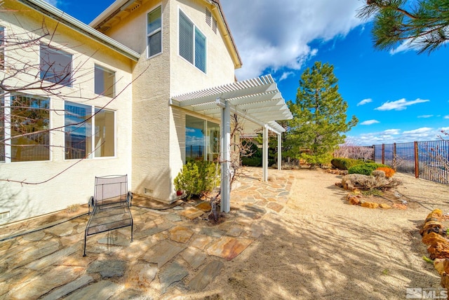 view of patio featuring a pergola and fence