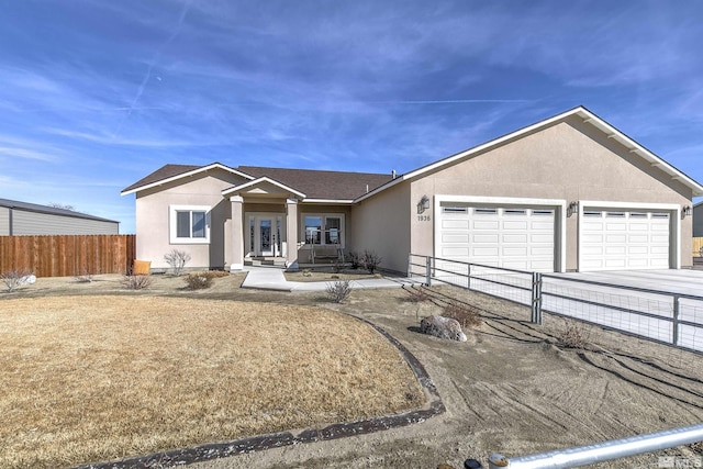 ranch-style house with a shingled roof, fence, concrete driveway, stucco siding, and an attached garage