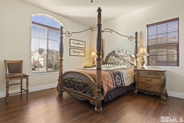 bedroom featuring visible vents, baseboards, and wood finished floors