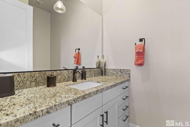 bathroom with visible vents and vanity