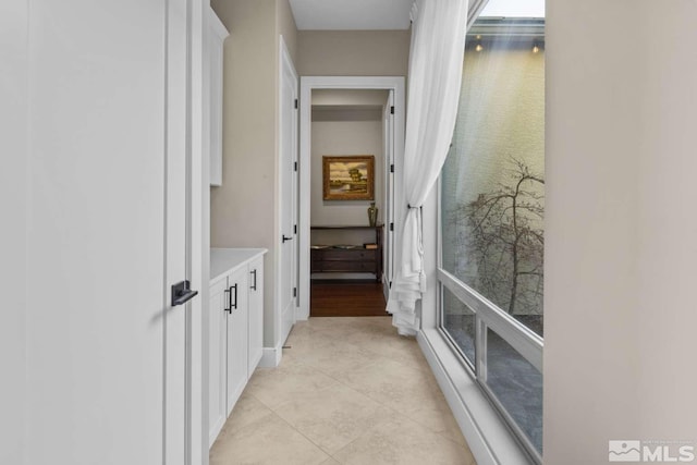 hall featuring light tile patterned floors