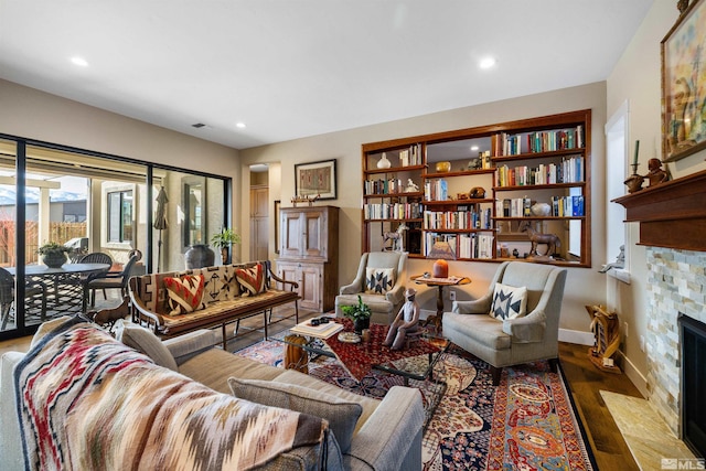 living room featuring wood finished floors, recessed lighting, a fireplace, and baseboards