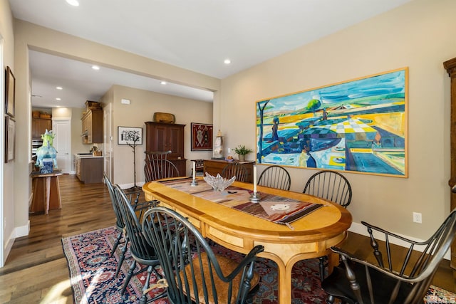 dining room with recessed lighting, baseboards, and wood finished floors