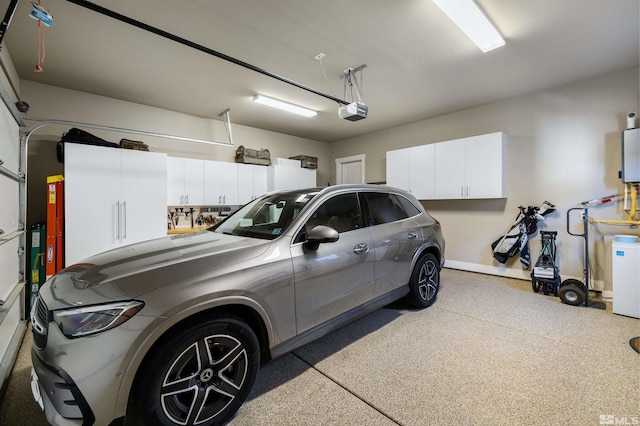 garage featuring a garage door opener and baseboards