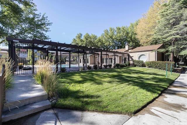 surrounding community featuring fence, a lawn, and a pergola