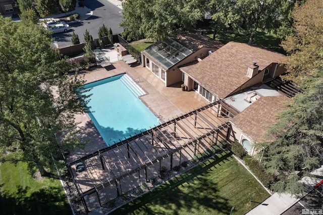 pool with a patio and fence