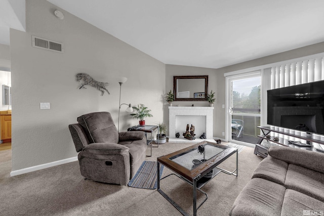 living room featuring visible vents, light carpet, lofted ceiling, baseboards, and a brick fireplace