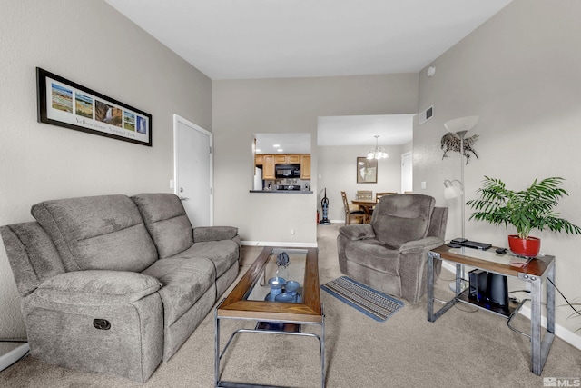 carpeted living area with a chandelier, visible vents, and baseboards