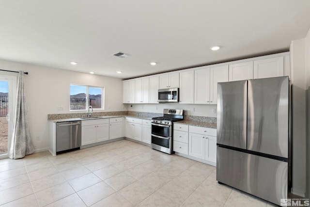 kitchen with visible vents, recessed lighting, stainless steel appliances, white cabinetry, and a sink