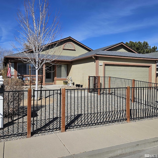 single story home featuring concrete driveway, a garage, and a fenced front yard