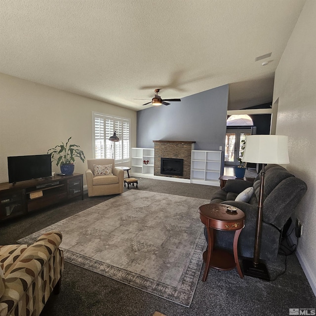 living room featuring baseboards, carpet floors, a fireplace, a textured ceiling, and a ceiling fan