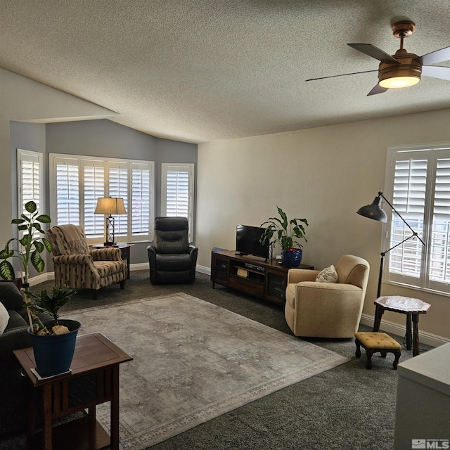 living room with a ceiling fan, carpet, and a textured ceiling