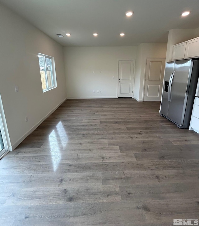 interior space featuring recessed lighting, baseboards, and wood finished floors