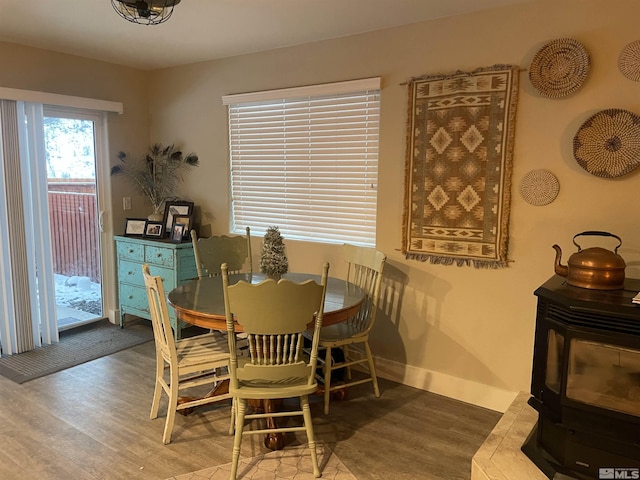 dining space featuring baseboards and wood finished floors