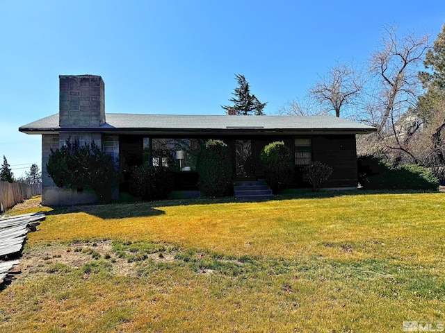 view of front of home with a front lawn and a chimney