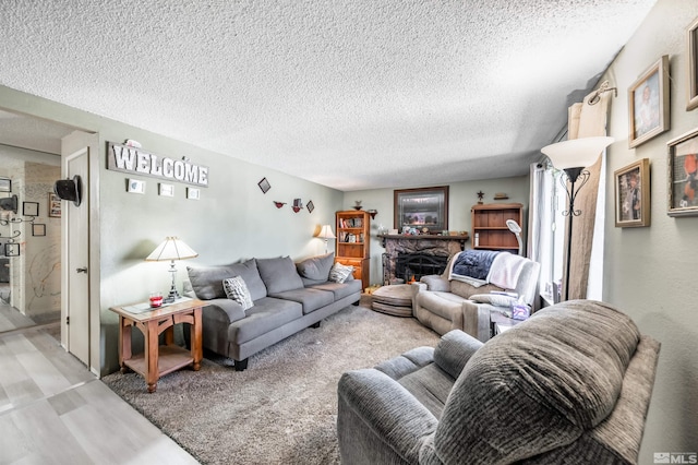 living area with a fireplace and a textured ceiling