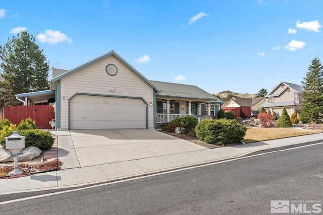 single story home with covered porch, concrete driveway, an attached garage, and fence