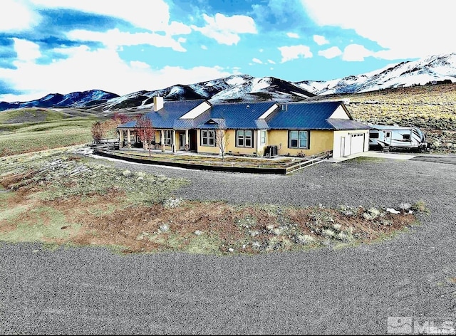 view of front of house featuring a mountain view, a garage, and driveway