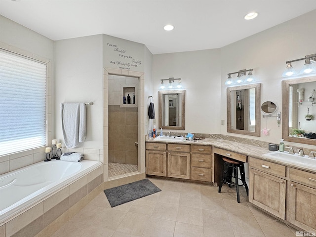 bathroom with a tile shower, tile patterned flooring, vanity, and a garden tub